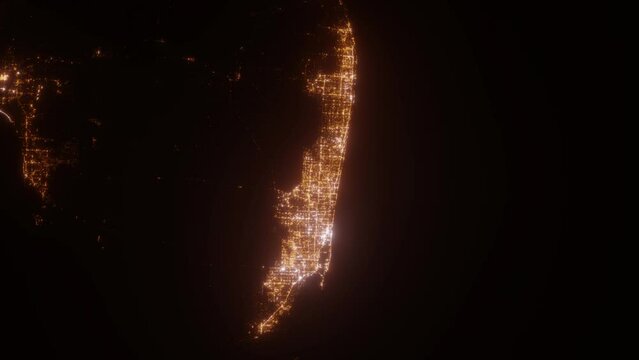 Miami area (Florida, USA) aerial view at night. Top view on city from space. Camera is zooming in, rotating clockwise