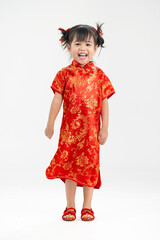 Happy little asian girl wearing cheongsam with greeting gesture celebrating for Chinese New Year in isolated white background.