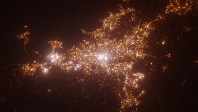Brisbane (Australia) top view at night. Aerial view on modern city with lights. Camera is flying above the city, moving backward. Vertical video. The north is on the left side