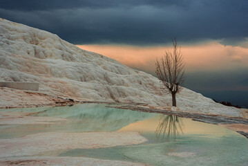 Travertines of Pamukkale in winter. Turkish famous white thermal bath with healthy clear water at...
