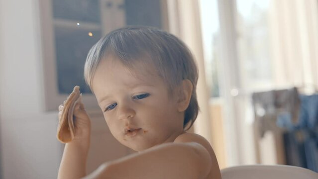 A video showcasing a young boy engaging in the act of eating food.