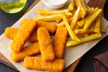Fish fingers with french fries and white sauce. Sea food. Fish and chips.