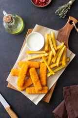 Fish fingers with french fries and white sauce. Sea food. Fish and chips.