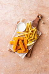 Fish fingers with french fries and white sauce. Sea food. Fish and chips.
