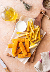 Fish fingers with french fries and white sauce. Sea food. Fish and chips.
