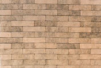Fototapeta premium The background is a brown, brick wall. textured brick backdrop