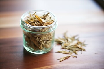 dried stevia leaves in a glass jar - obrazy, fototapety, plakaty
