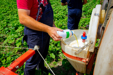Farmer prepare mix of herbicide and pesticide for biochemical crop treatment