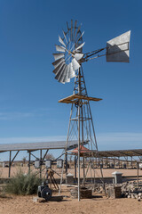 old windmill on sand at Canyon Roadhouse, Namibia