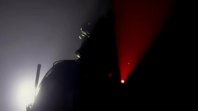 Silhouette, special forces warrior aims by weapon assault rifle carbine. Swat fighter points tactical red laser sight directly at camera. Shadow mercenary. War concept. Military soldier. Army commando