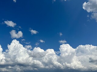 Bright blue sky with fluffy white clouds on a sunny day
