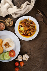 Chicken Tongseng or Tongseng ayam is an Indonesian meat or mutton stew dish in curry like soup with coconut milk, chili and sweet soy sauce. 