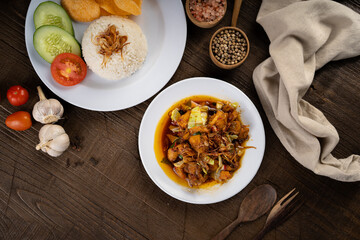 Chicken Tongseng or Tongseng ayam is an Indonesian meat or mutton stew dish in curry like soup with coconut milk, chili and sweet soy sauce. 
