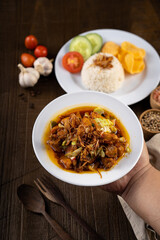 Chicken Tongseng or Tongseng ayam is an Indonesian meat or mutton stew dish in curry like soup with coconut milk, chili and sweet soy sauce. 