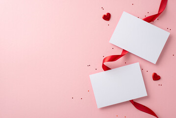 Love note essentials. Top view capturing unused postcards, satin ribbon, heart shapes, and sparkles...