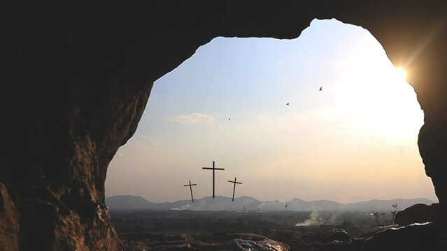 Three crosses on the hill and Jesus tomb Easter, resurrection, new life, redemption concept.