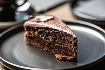 Sacher cake with coffee on the table in the cafe.