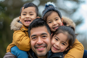 Happy father giving his children piggyback rides