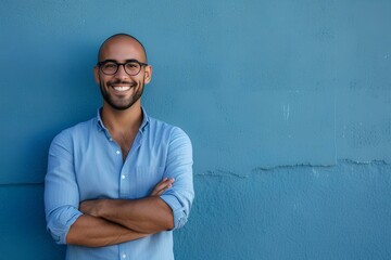 clever wit hispanic man standing smiling in a blue shirt on contemporary blue background with arms crossed. generative AI - obrazy, fototapety, plakaty