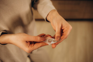 Woman opening a case containing a contact lens. Vision Correction and Health Care. Contact Lenses.