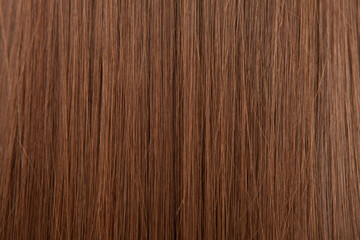 Naklejka premium Close up of brown hair as background. Texture of natural hair..