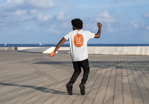 Mockup of man wearing customizable t-shirt, rear view