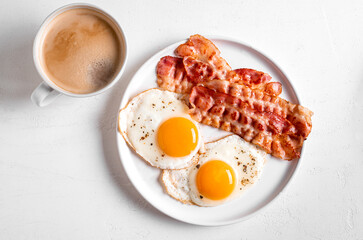Breakfast with fried eggs, bacon and coffee