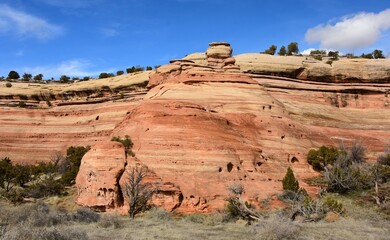eroded red rock cliffs on a sunny spring day hiking in mcinnis canyons national conservation area,...