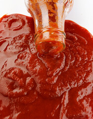 Tomato sauce . Glass bottle with ketchup. Ketchup is pouring out of the neck of a glass bottle.