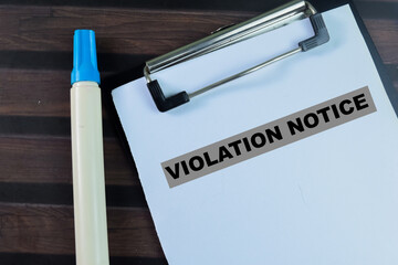 Concept of Violation Notice write on paperwork isolated on wooden background.