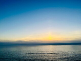 Orange sea horizon, rocky coast, evening seascape background
