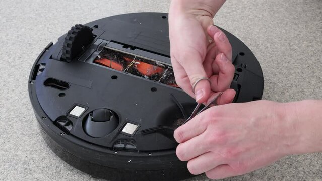 Cleaning tangled hair out of automatic vacuum cleaner
