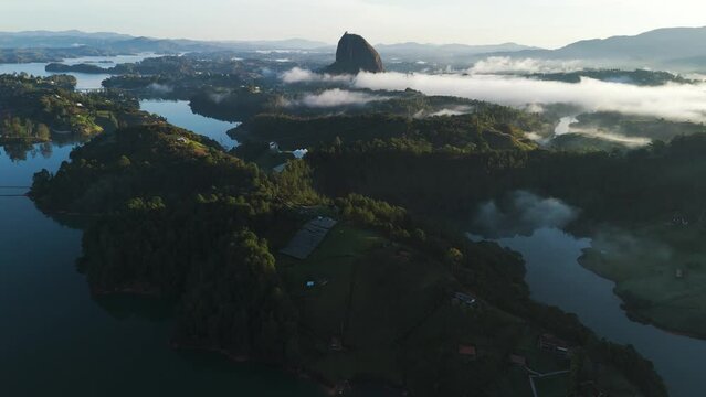 Cinematic Aerial Tilt-up Reveal of Guatape, Colombia Landscape at Sunset