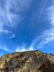 Fototapeta na wymiar Natural rocky hill in the blue sky
