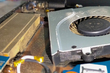 Laptop CPU thermal board cooling fan blades that are clogged with dust. Technical nuances in the...