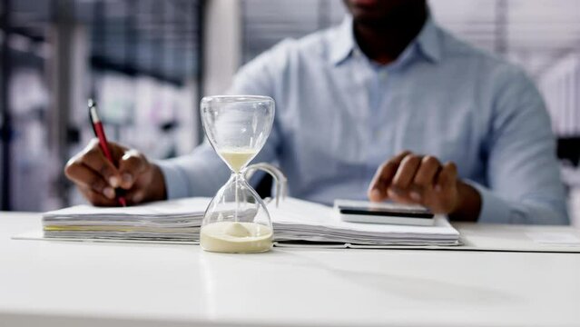 Hourglass And Time Crunch With Document