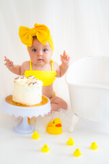 Girl in a yellow swimsuit and birthday cake
