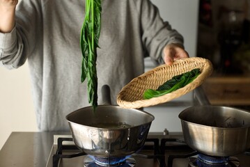 茹で上がったほうれん草をざるにあげるところ