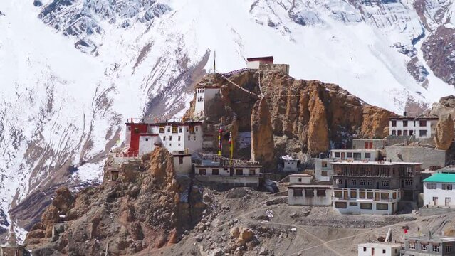 Closeup shot of snow covered Dhankar Monastery during the winter season in front of snowy Himalayan mountains at Spiti Valley in Himachal Pradesh, India. Old monastery made on cliff in the mountains. 