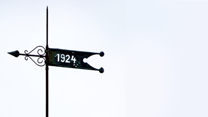 Custom made weathervane in Germany with a year on a banner. In this case 1924. With space for your own text - obrazy, fototapety, plakaty