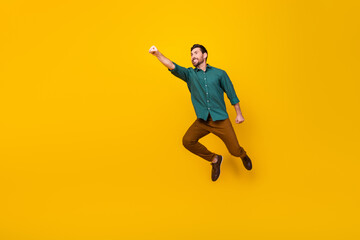 Fototapeta na wymiar Full length photo of purposeful man dressed dotted shirt look empty space fly like superhero isolated on vibrant yellow color background