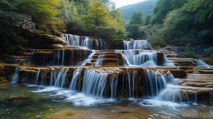 Foto op Canvas A series of cascading waterfalls creating natural terraces in a mountainous region. © Melvin