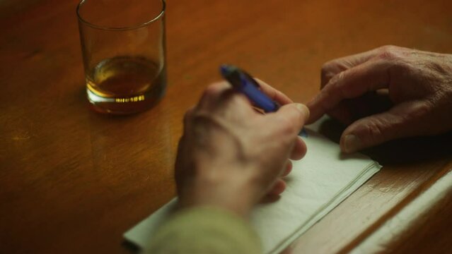 Man Draws On Bar Napkin