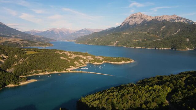 Summer aerial view of Serre-Poncon Lake with Chanteloube Bay and its submerged viaduct. Durance Valley with Grand Morgon peak in Hautes-Alpes (Alps), France