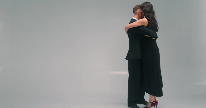 talented active young people dancing tango loving couple attending dance School, slow motion