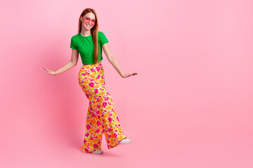 Full length photo of positive girl wear stylish top print trousers dancing in glasses at vintage party isolated on pink color background