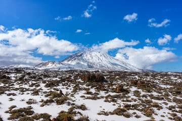 Volcano Del Teide under the snow with a desert in the foreground . Tenerife, Canary Islands, Spain. - 726367204