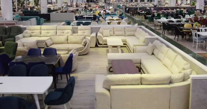 A drone flies through a large furniture store