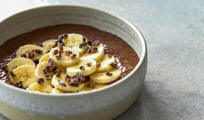 Chia pudding, plant based breakfast, healthy vegetarian food. Vegan superfood with berries, sliced banana. Mixed vegetarian meal for restaurant, menu, advert or package, close up, selective focus