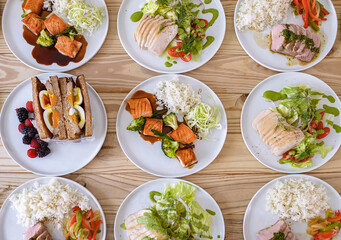 Set of plates with healthy balanced diet delicious meal with vegetables, chicken, rise. Homemade food for menu, advert or package, selective focus